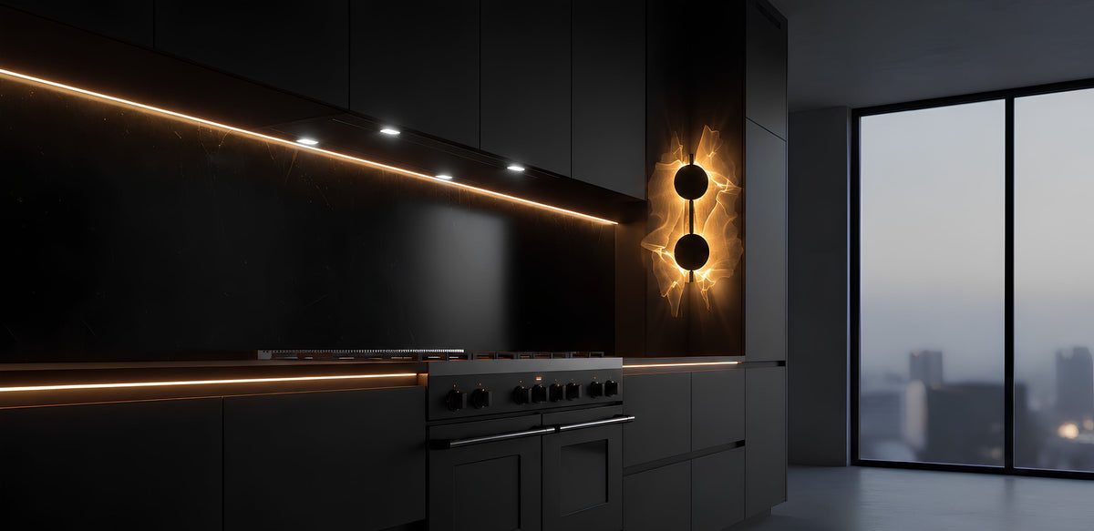 A modern dark kitchen interior with matte black cabinets, integrated cooktop and oven, warm under-cabinet lighting, and a large floor-to-ceiling window overlooking a city skyline at dusk.